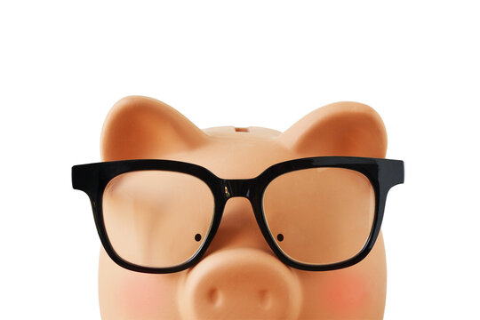 Close-up of piggy bamk with eyeglasses - Concept of economy, savings and money calculations