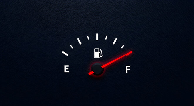 Close up view of a car fuel gauge showing the needle pointing towards the full indicator on a black textured background representing modern vehicle instrumentation panel systems for monitoring petrol 