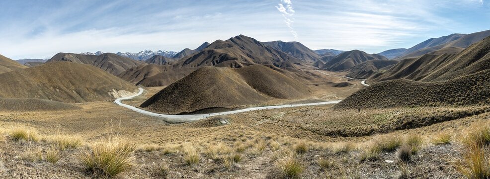 Barren mountain landscape with pass road, Lindis Pass, Southern Alps, Otago, South Island, New Zealand