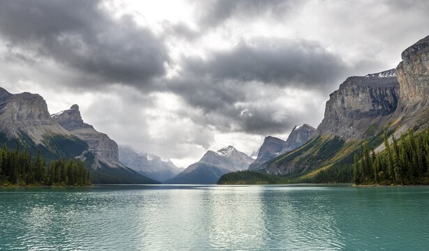 Turquoise blue glacial lake Maligne Lake, mountains Mount Paul, Monkhead and Mount Warren in the back, Maligne Valley, autumn, Jasper National Park National Park, Canadian Rocky Mountains, Alberta, Canada