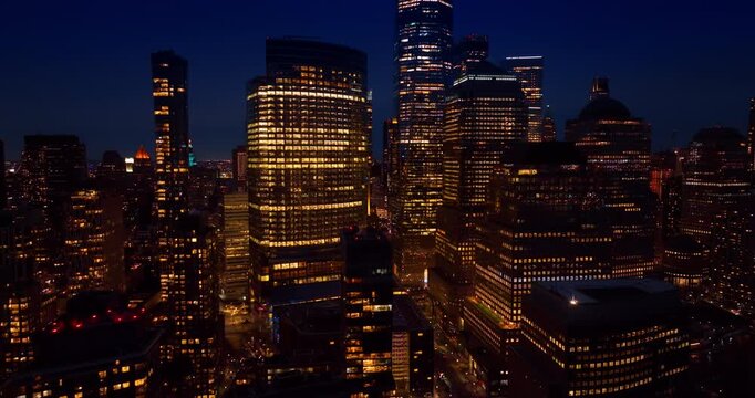 Sparkling buildings in the diverse architecture of modern New York City. Beautiful downtown of Big Apple at night from drone.