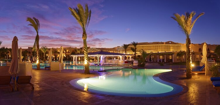 Swimming pool with palm trees at sunset, Hilton Nubian Resort, Al Qusair, Marsa Alam, Egypt