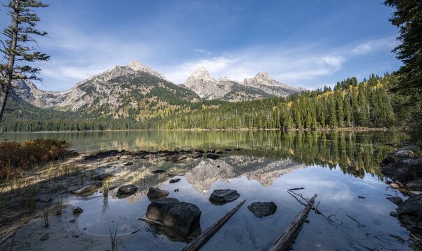 Reflection in Taggart Lake, view of the Teton Range, peaks Grand Teton and Teewinot Mountain, autumn, Grand Teton National Park, Wyoming, USA