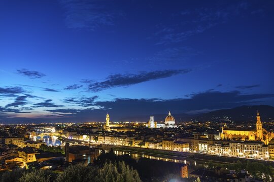 Illuminated city panorama at dusk with Florence Cathedral, Duomo Santa Maria del Fiore with the dome by Brunelleschi, Palazzo Vecchio, Ponte Vecchio, UNESCO World Heritage Site, Florence, Tuscany, Italy