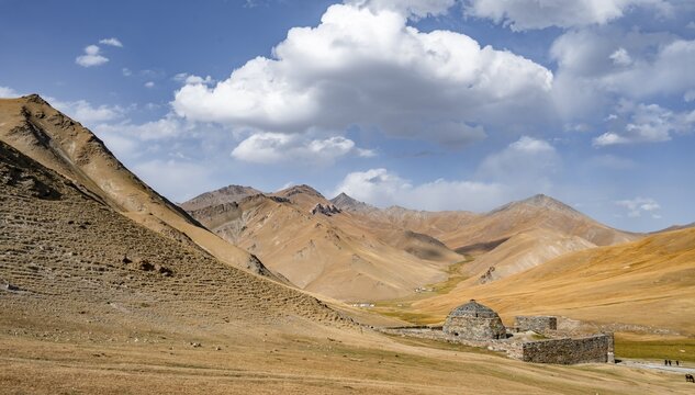 Historic caravanserai Tash Rabat from the 15th century, with yellow hills, Atbashy district in the Naryn region, Kyrgyzstan