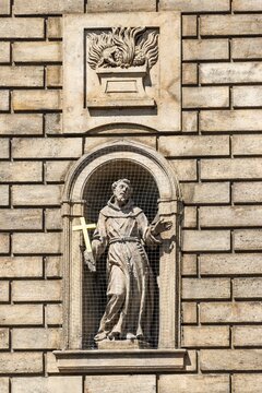 Statue of St. Francis of Assisi in a niche on the facade of the Church of the Knights of the Cross, Old Town, Prague