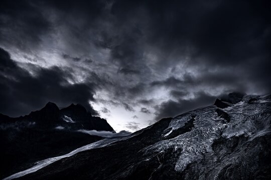 Bernina Group with Rosegg Glacier and dramatic clouds at blue hour, St Moritz, Engadin, Grisons, Switzerland