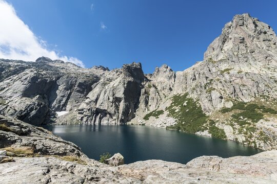 Mountain lake Lac de Melo surrounded by cliffs, source of the Restonica river, Restonica mountain valley, Corte, Haute-Corse, Corsica, France