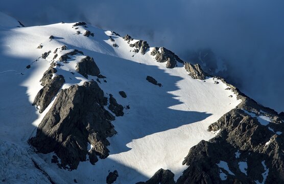 Snow covered rocky mountainside in evening light, Mount Sefton with Tucket Glacier and Huddelston Glacier, Mount Cook National Park, Canterbury Region, South Island, New Zealand