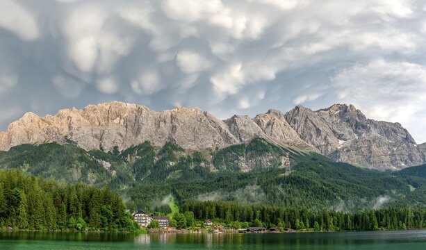 Eibsee lake in front of Zugspitze massif with Zugspitze, dramatic Mammaten clouds, Wetterstein range, near Grainau, Upper Bavaria, Bavaria, Germany