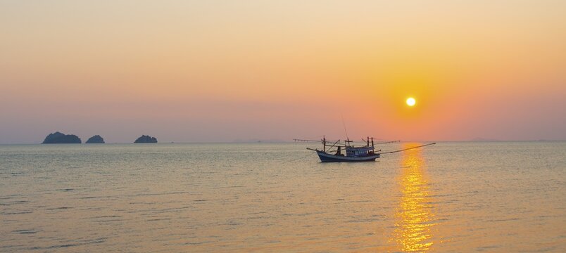 Boat in the sea at sunset in front of small islands, Koh Samui, Gulf of Thailand, Thailand