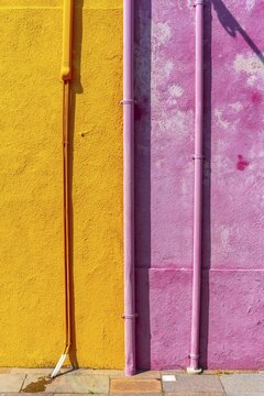 Pink and yellow wall with gutter and cable, colorful house wall, colorful facade, Burano Island, Venice, Veneto, Italy