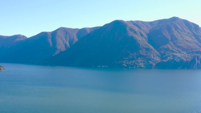 Aerial view of Lake Ceresio in Lugano, panning and tilting