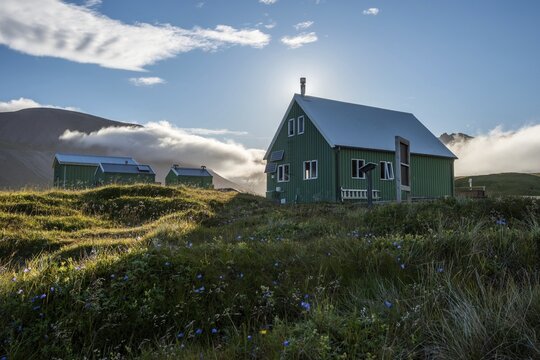 Huts of the Icelandic Hiking Club in the backlight, Brei&eth;av&iacute;k, East Fjords, V&iacute;knasl&oacute;dir, Iceland