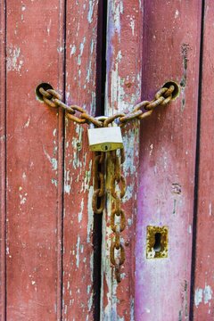 Lock on a chain, wood door