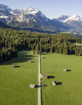 Hay barns in a meadow, Ehrwalder Sonnenspitz and mountains, near Ehrwald, Mieminger Kette, Tyrol, Austria