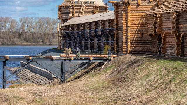 Reconstruction of an ancient log wall and bridge across the fortress moat in the Uglich Kremlin. Uglich, Russia.