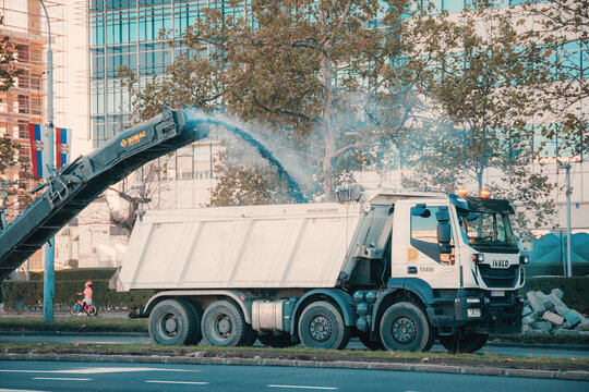 25 October 2025, Belgrade, Serbia: Heavy construction machinery working on road pavement during urban street repair