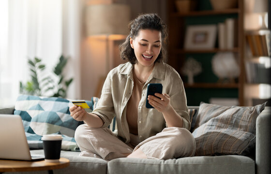 Happy Woman Shopping Online with Credit Card and Smartphone at H