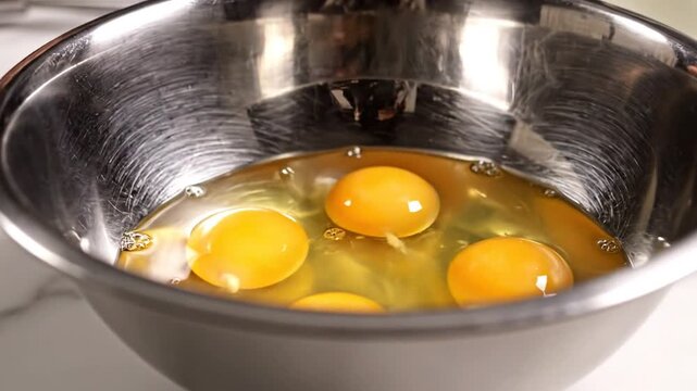 Fresh Eggs Ready for Cooking in a Metal Bowl
