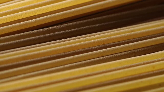 Spaghetti pasta slowly sliding, close-up, texture.