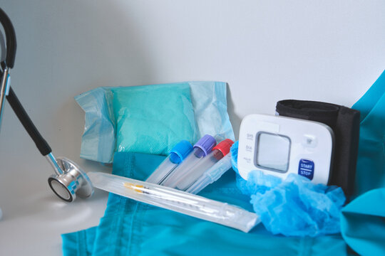 Assortment of medical instruments and supplies on a teal uniform for health and wellness