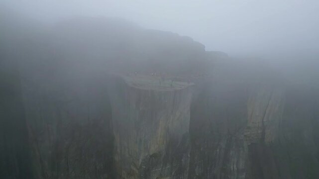 Far Away Aerial View of Preikestolen Mountain Cliff During Fog 4k drone