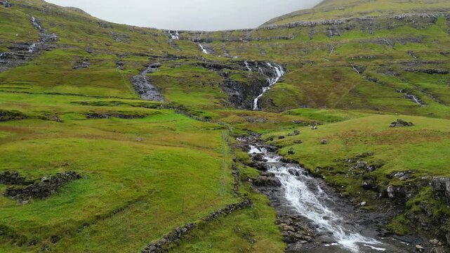 Cinematic aerial uphill drone footage of waterfalls at the Faroe islands, Denmark