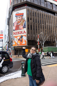 Portrait Beautiful asian fat woman smile happy travel and Standing on Sidewalk with Mountain and Cityscape Background. Enjoying a Sunny Winter Day in a Picturesque Town. posture suggests curiosity