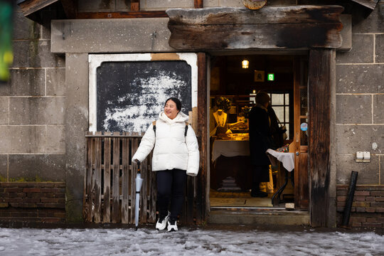 Traditional Japanese Street. Portrait Beautiful asian fat woman smile happy travel and Standing on Sidewalk with Mountain and Cityscape. Enjoying a Sunny Winter Day in Picturesque Town