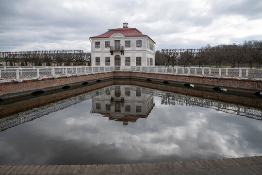 PETRODVORETS, RUSSIA - APRIL 18, 2026: Marley's Palace with reflection in the Sectoral Pond. Peterhof Museum-Reserve
