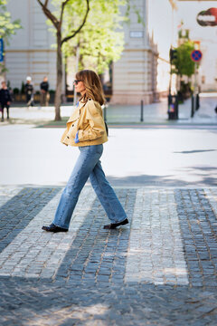 Full length a confident woman walking across the pedestrian crossing