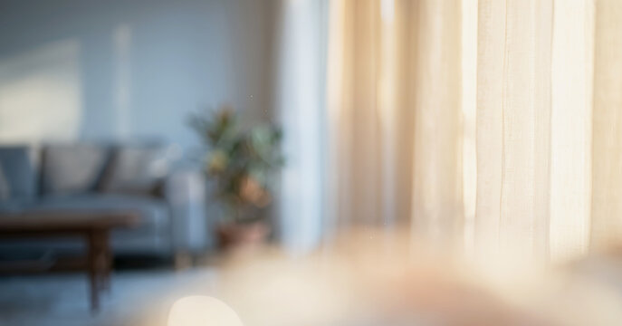 A softly lit living room interior featuring a blurred view of curtains, a cozy sofa, and a plant, creating a serene and inviting atmosphere.