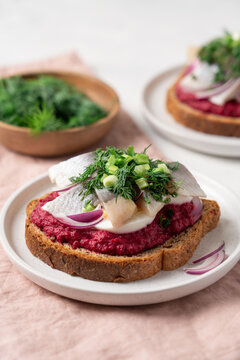 Open sandwich with herring beetroot mousse egg dill and green onion, traditional Scandinavian cuisine appetizer concept