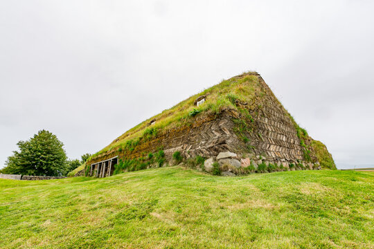 Arafed building with grass on top of it in a field, Lauf?s heritage site, Grass-roofed houses and church from 19th century offer insights into early Icelandic life. Northern Iceland