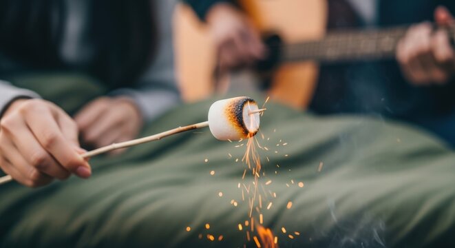 Cozy campfire night with friends roasting marshmallow while relaxing with acoustic guitar in outdoor setting. Evening campfire activities create warm memories of friendship and music around fire.
