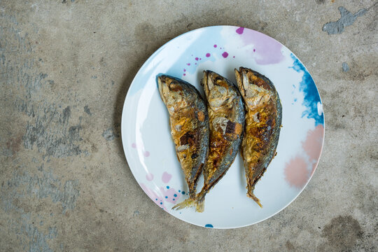Deep fried mackerel served on dish, top view