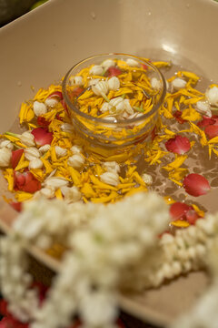 A bowl with jasmine flowers and petals of flowers for the Songkran festival ritual. Traditional Thai water blessing ceremony for respect and good fortune
