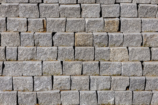 Grey granite cobblestones forming textured retention wall