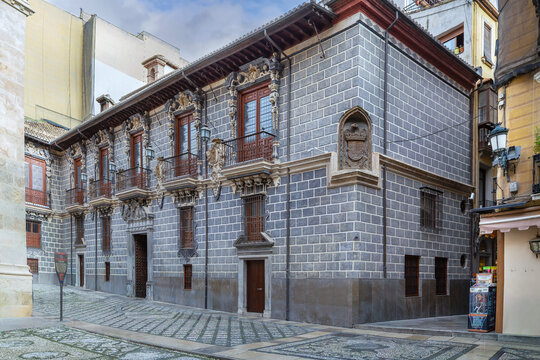 Baroque facade of Palacio de la Madraza in Granada Spain with five balconies. Gray stone building next to Granada Cathedral