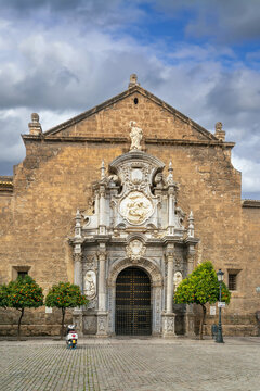 Facade of Church of Santos Justo y Pastor in Granada Spain. Baroque religious architecture with stone statues and portal