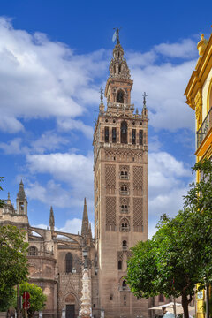 The Giralda bell tower of Seville Cathedral in Spain. Ancient Mudejar and Renaissance architecture under clear blue sky