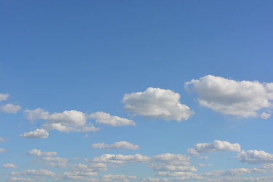 Bright nice weather, relaxation, entertainment, beauty, freedom. A beautiful blue sky with fluffy white clouds floating over the river.