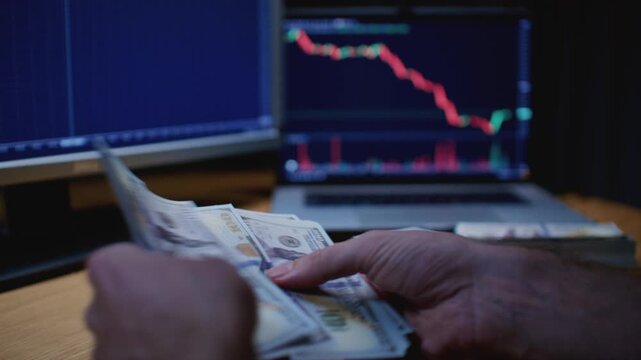 Close up: man trader or businessman counts salary usd banknotes at home with his hands. Male entrepreneur holds stack of dollar bills in palms, keeps money records for budget. Counting american paper