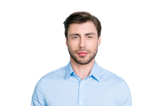 close up portrait of successful brunet man looking at camera with kind and a little bit tricky glance while standing over grey background