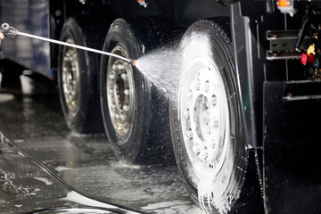 Professional cleaning of truck wheels and rims using high-quality foam and water services, ensuring a spotless shine. Perfect for automotive enthusiasts and detailing services. © Aleksandr