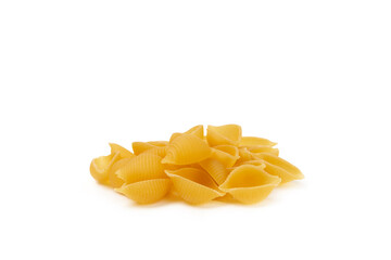 Fototapeta premium Raw Conchiglie pasta isolated on white background. tasty raw Conchiglie. close-up. Banner. Raw pasta in a jar, wooden spoon. Raw Italian pasta, European cuisine. Design. 