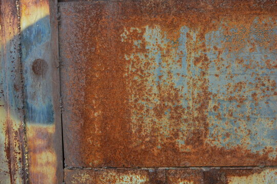 Things, unusual objects, old metal garage doors covered with very deep rust, red metal covered with corrosion, metal structures welded together.