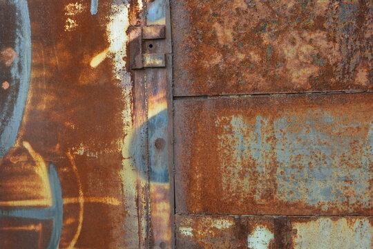 Things, unusual objects, old metal garage doors covered with very deep rust, red metal covered with corrosion, metal structures welded together.