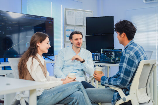 Diverse Tech Team Collaborating and Discussing Project Strategy During Coffee Break in Modern AI Office